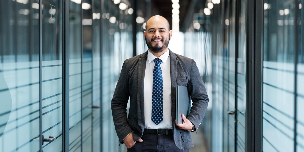professional man smiling, in the office
