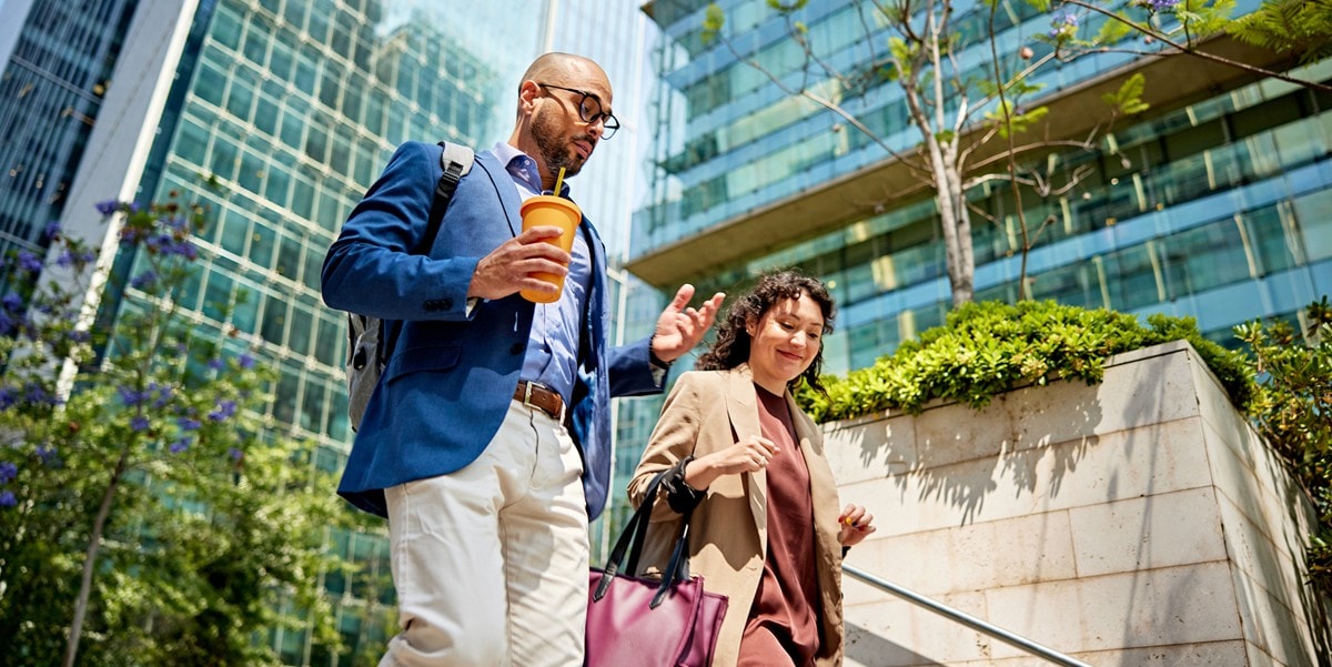 two professionals walking down steps outside building