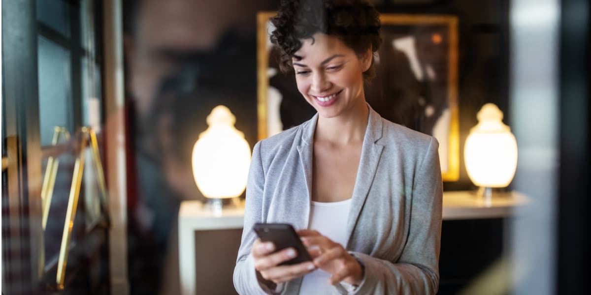 woman on a device smiling